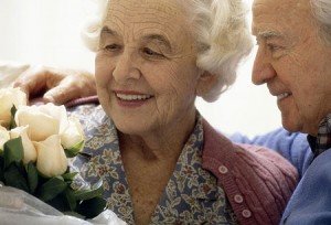 Elderly couple with flowers